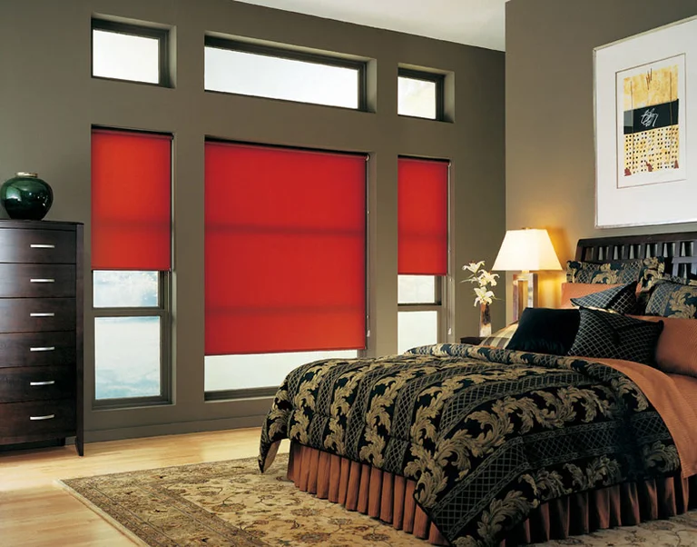 Red roller shades in a bedroom